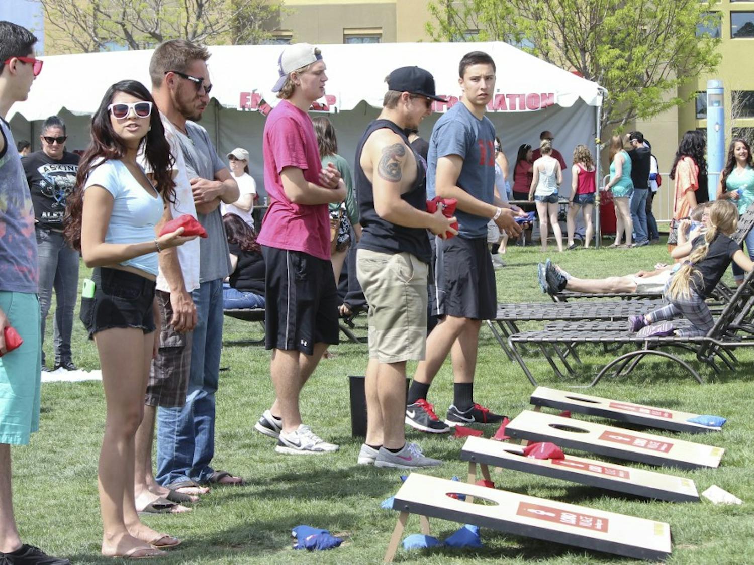 UNM students play bean bag toss on Johnson Field Saturday afternoon during Fiestas. 