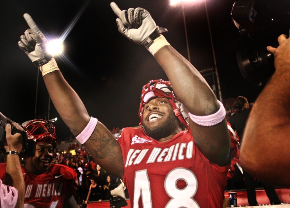 	UNM defensive end Jaymar Latchison celebrates with teammates and fans at University Stadium. The Lobos defeated Wyoming 34-31 on Saturday for UNM’s first win of the season.  