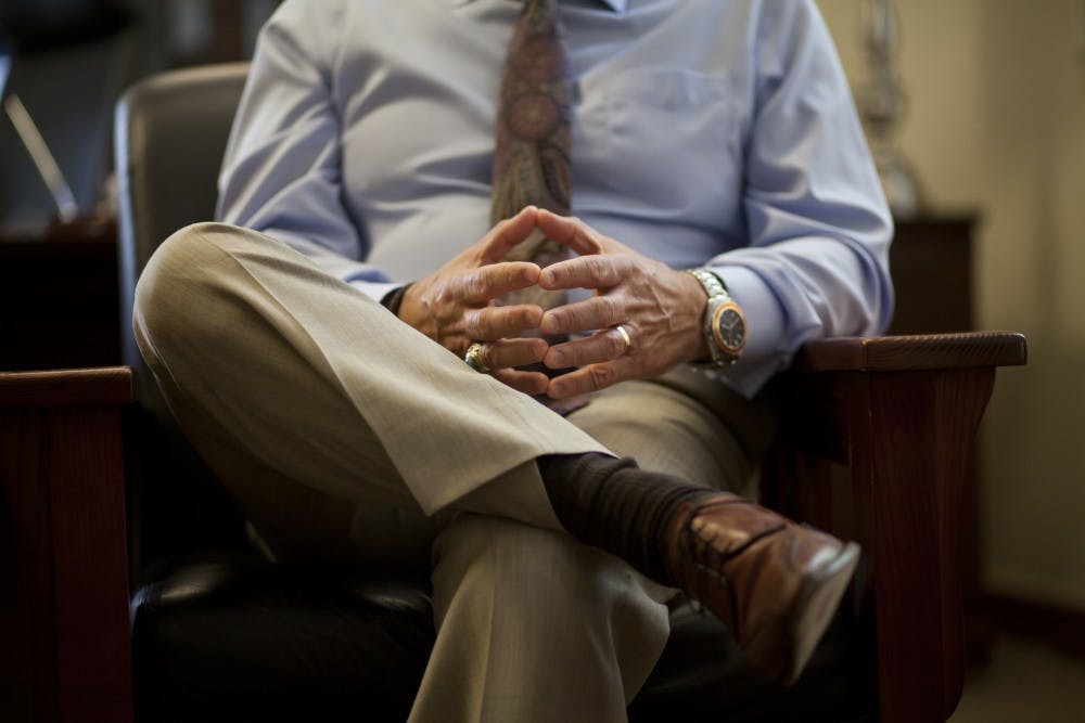 President Robert Frank puts his hands together in his office June 17, 2013.&nbsp;Due to lack of tuition revenue, Frank told the told the Board of Regents that the University will not fill vacant staff positions in the future.&nbsp;