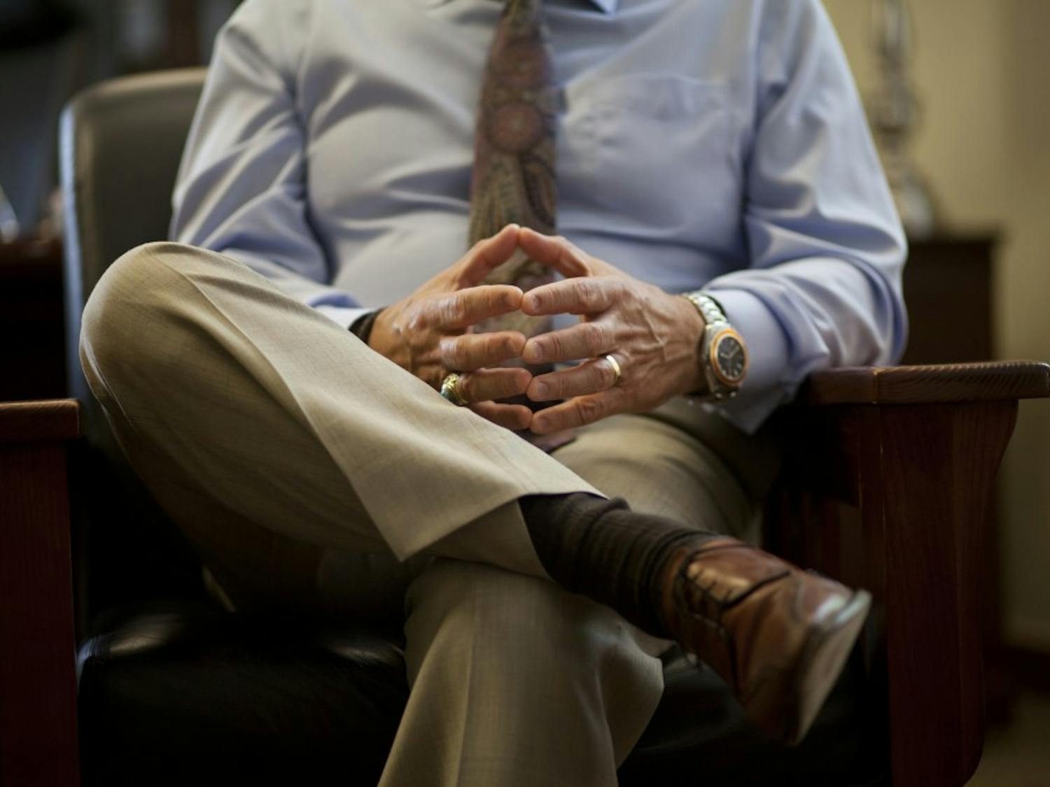 President Robert Frank puts his hands together in his office June 17, 2013.&nbsp;Due to lack of tuition revenue, Frank told the told the Board of Regents that the University will not fill vacant staff positions in the future.&nbsp;