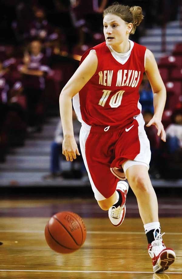 UNM guard Amy Beggin goes for the ball during Sunday's 58-42 loss against NMSU in Las Cruces. Beggin sustained a concussion during the second half of the game.