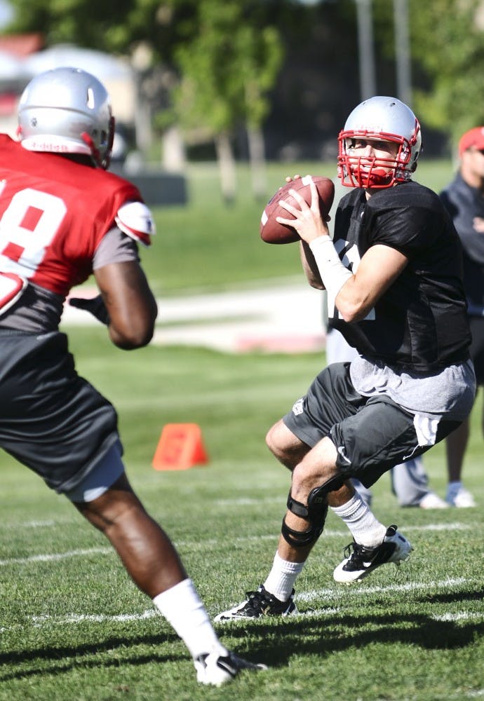 	B.R. Holbrook leans back before a pass at practice Tuesday. Holbrook will start as quarterback during the Lobos first game at Oregon.