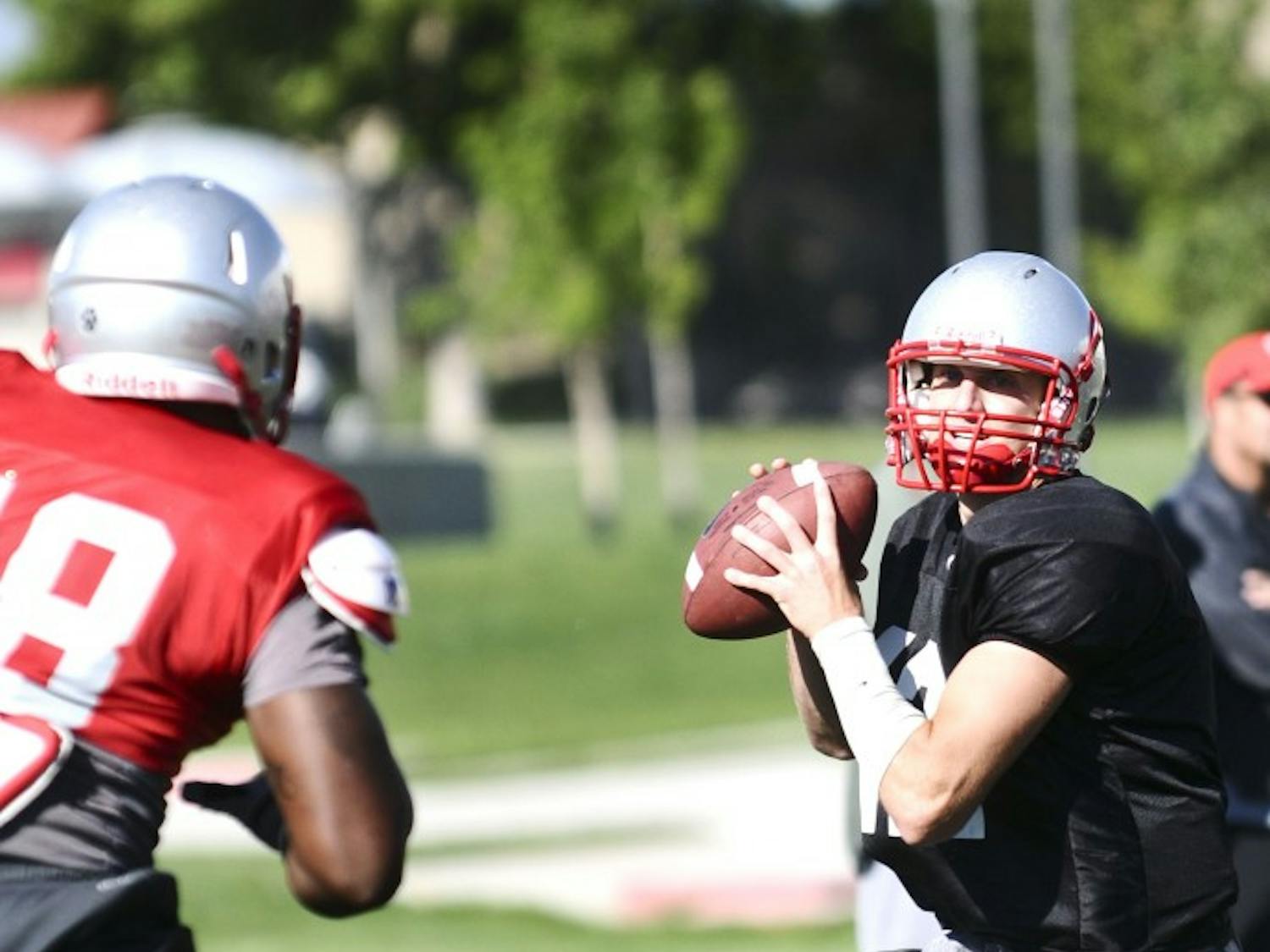 	B.R. Holbrook leans back before a pass at practice Tuesday. Holbrook will start as quarterback during the Lobos first game at Oregon.