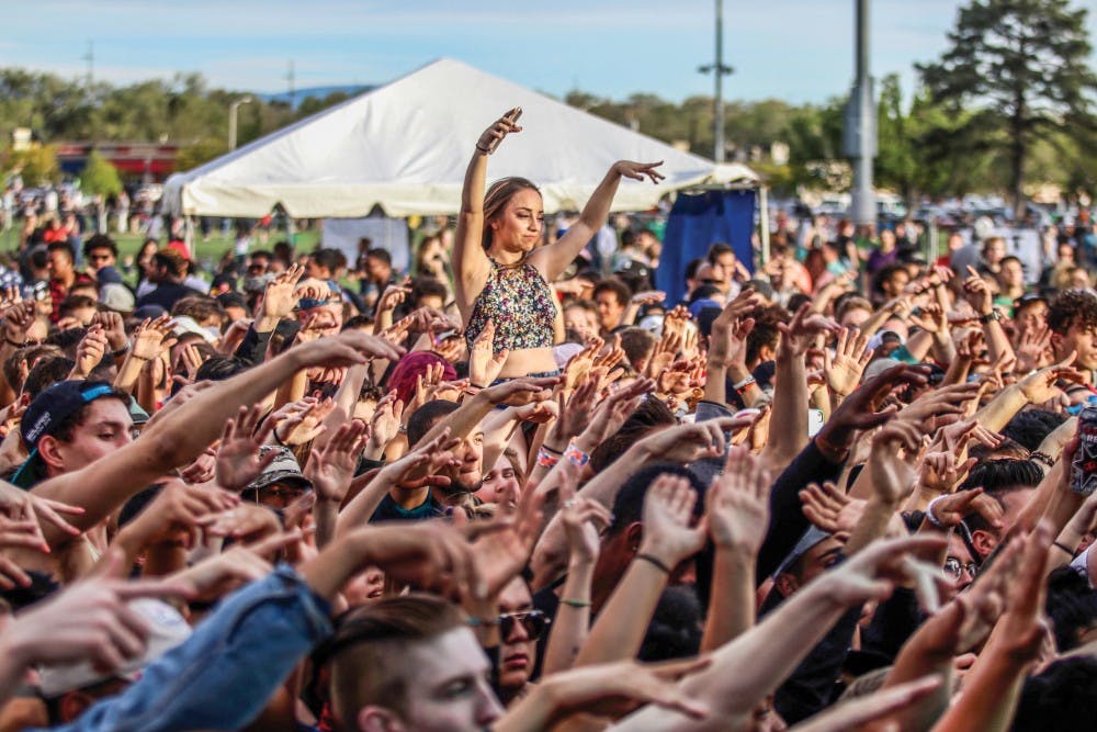 A crowd of attendees raises their hands during the 2017 Fiestas event on Saturday, April 8, 2017 on Johnson Field.