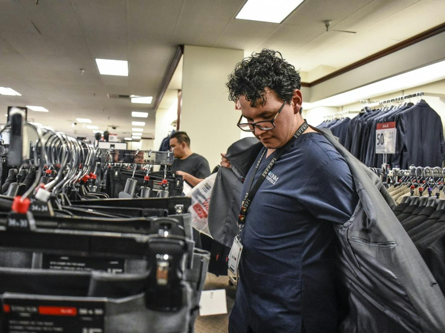 A University of New Mexico Hospital employee shops for a suit during College Suit Up on Sunday, Aug. 26.