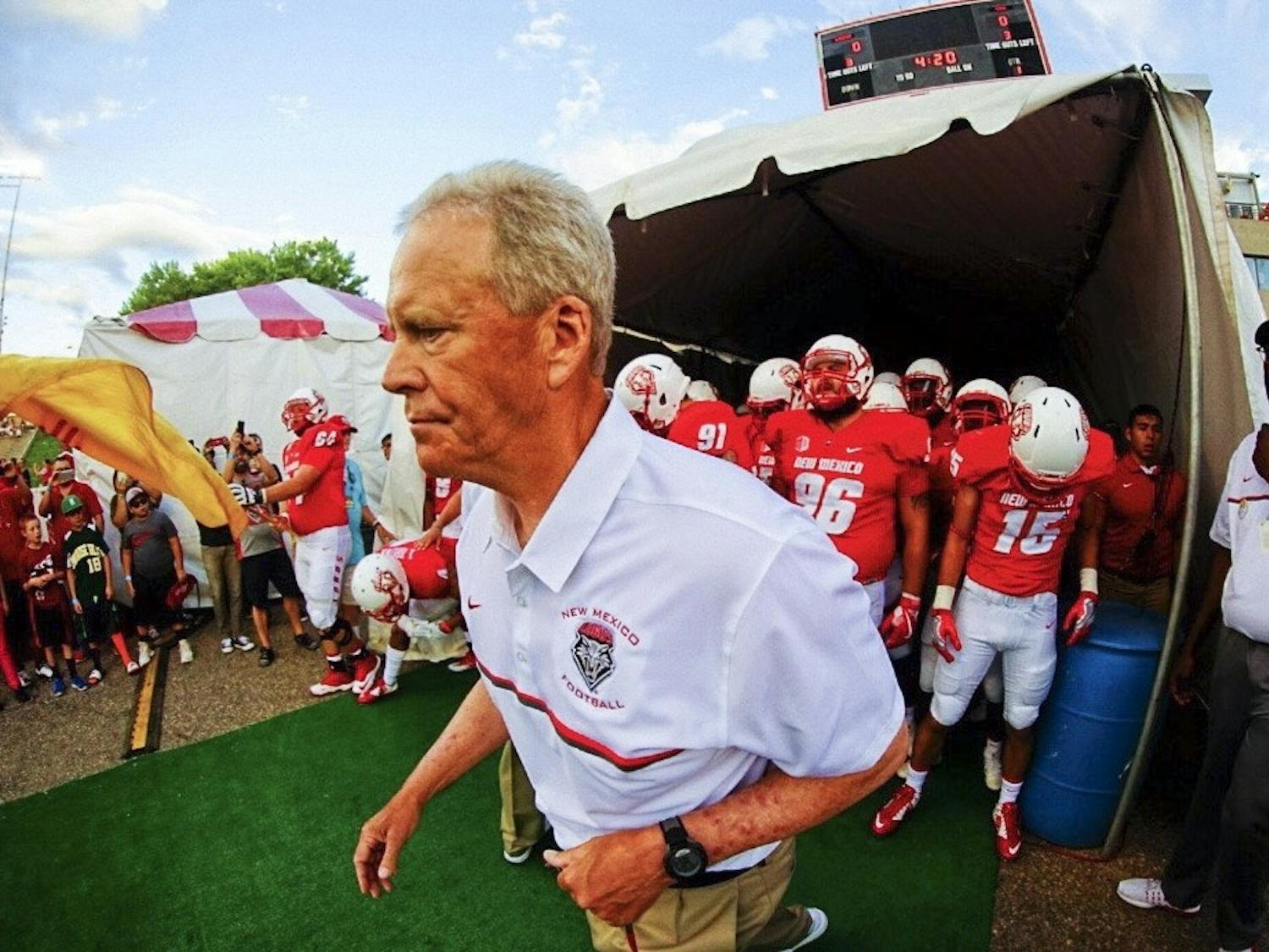 UNM football head coach Bob Davie leads the Lobos out of the tunnel on Sept. 1, 2016 at University Stadium.