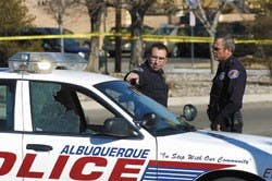 An officer whose name the Albuquerque Police Department would not release points to his damaged car on Coal Avenue on Monday. Jay Ulibarri, 35, shot at the police vehicle after the officer tried to pull him over. Police arrested Ulibarri after he took a 5