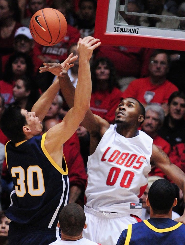 	Forward A.J. Hardeman swats a shot by UC-Riverside’s David Chavira during UNM’s opening regular-season game Saturday at The Pit. The Lobos won 67-51 and Hardeman had 14 points in 28 minutes.