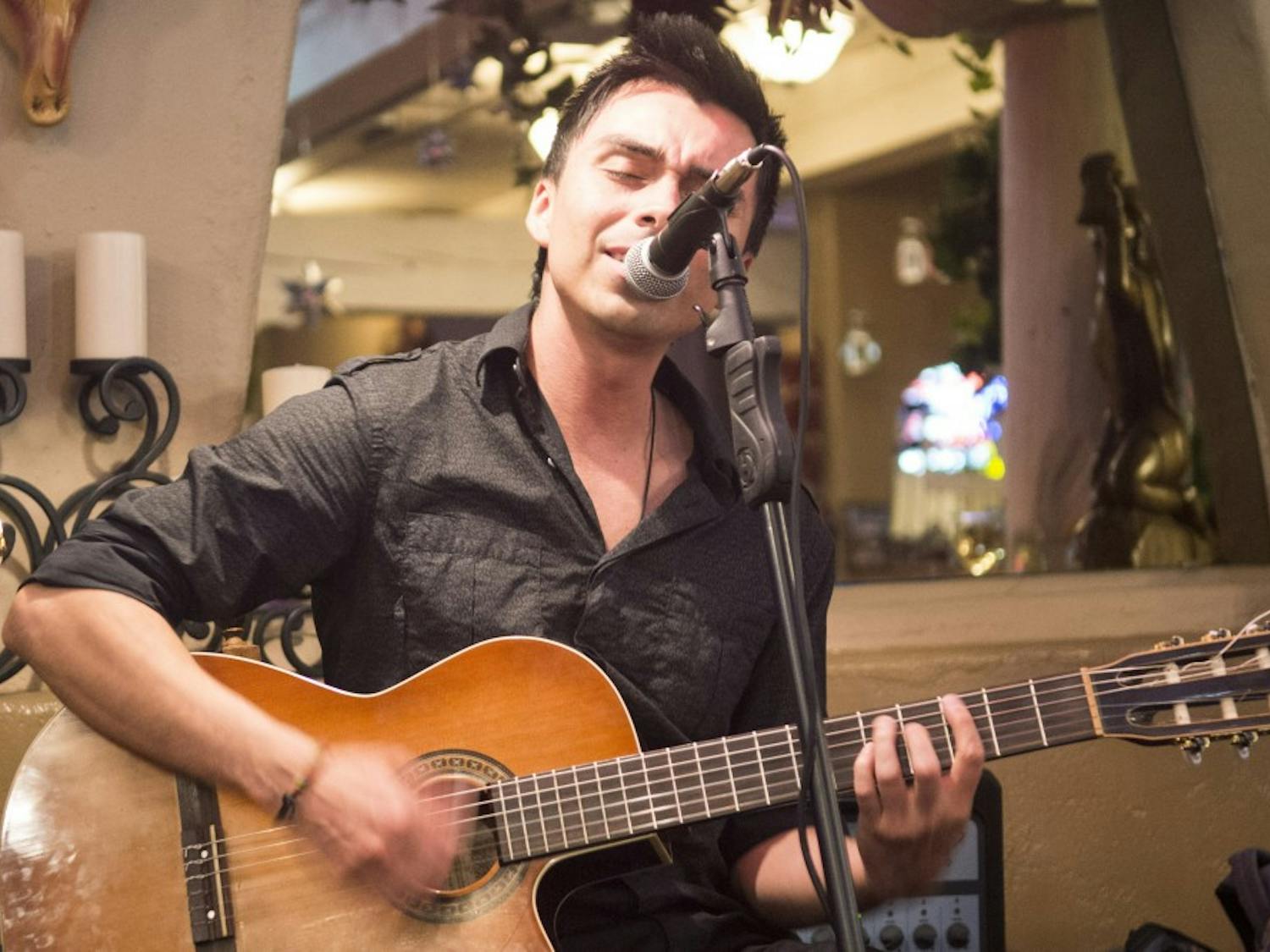Diego Manrique, senior Music major, plays at Hacienda del Rio restaurant in Albuquerque’s Old Town on Oct. 21. Manrique and three other students formed a latin music band called Sol de La Noche to play at different restaurants and locations.