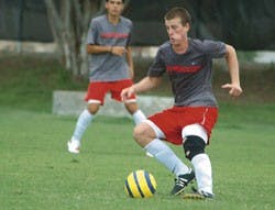 Lobo midfielder Michael Reed gets ready to pass the ball during a scrimmage at Robertson Field on Monday.