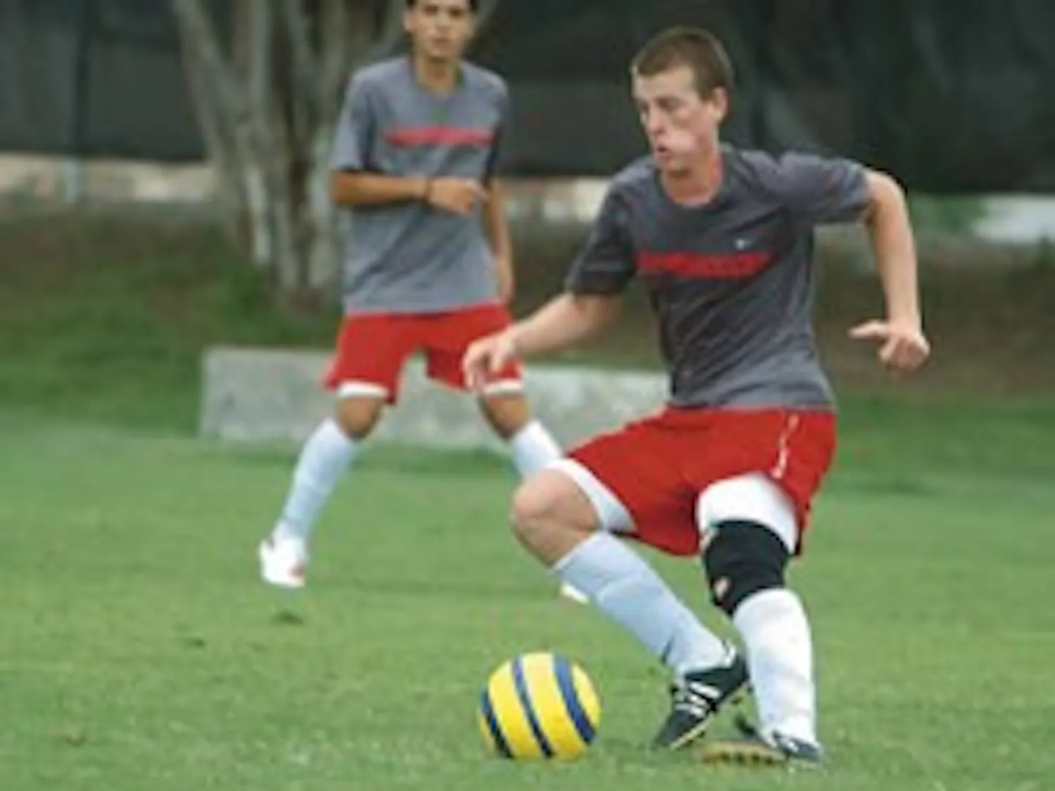 Lobo midfielder Michael Reed gets ready to pass the ball during a scrimmage at Robertson Field on Monday.