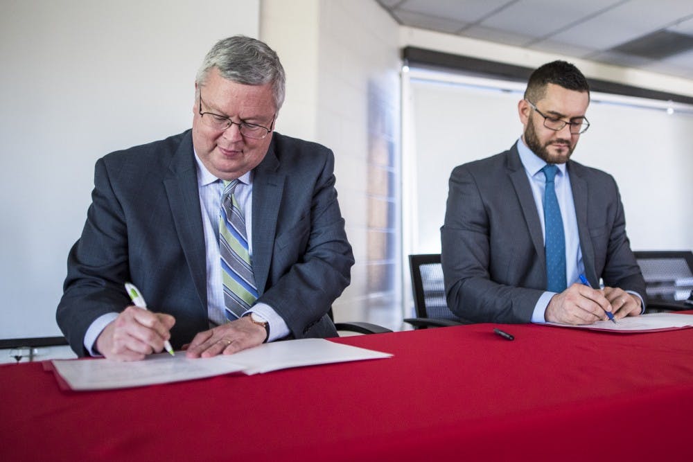 UNM Dean of Arts and Sciences Mark Pencey, right, and Miklail Osadchiy, the vice-rector of the Pushkin Institute sign an agreement making UNM the second school to partner with the institute. The focus of the agreement is to help aid the education of the Russian language. 