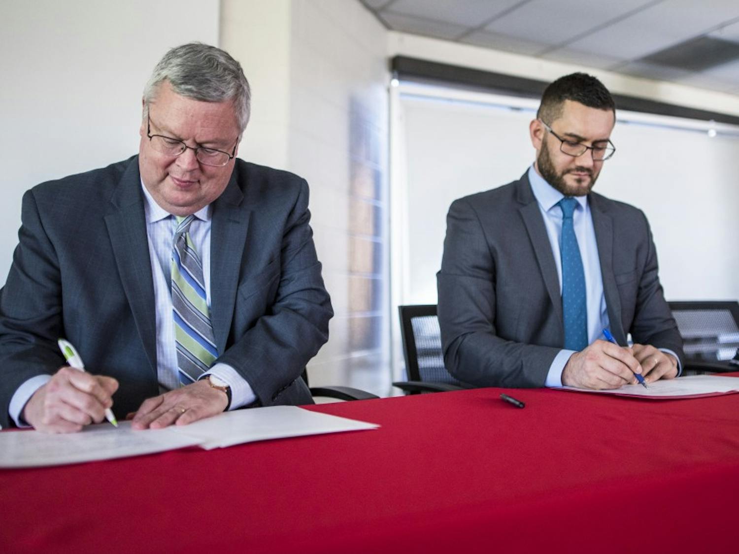 UNM Dean of Arts and Sciences Mark Pencey, right, and Miklail Osadchiy, the vice-rector of the Pushkin Institute sign an agreement making UNM the second school to partner with the institute. The focus of the agreement is to help aid the education of the Russian language. 
