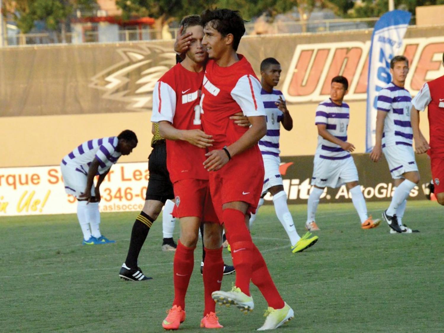 Chris Wehan and Francesco Cassuci congratulate each other during an exhibition game against Grand Canyon University on Aug. 19. The Lobos play at top-ranked UCLA this Saturday for the season opener.