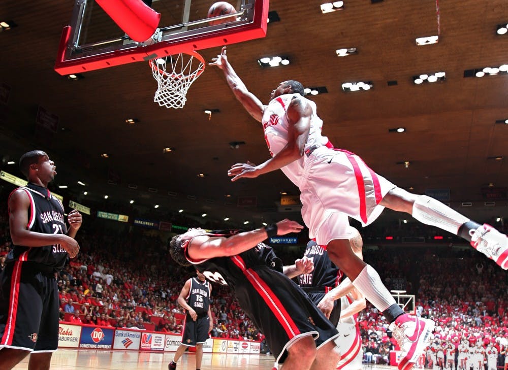 UNM guard J.R. Giddens scores against San Diego State forward Ryan Amoroso during Saturday's 72-67 loss at The Pit.