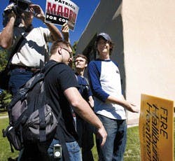 Wayne Johnson, a cameraman for the Heather Wilson campaign, tries to record a speech by Patricia Madrid, Democratic candidate for the U.S. House of Representatives, outside Zimmerman Library on Thursday. Madrid's supporters tried to prevent Johnson from r