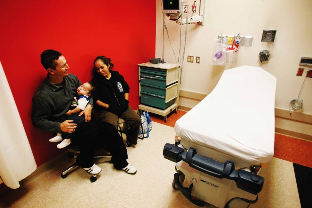 Omar Garcia and Teresa Herrera, parents of Omar Garcia Jr., wait at the pediatric unit of the Barbara and Bill Richardson Pavilion on June 9. Admitted for a fever, Omar Jr. is the first patient to be treated at the new pediatric unit.