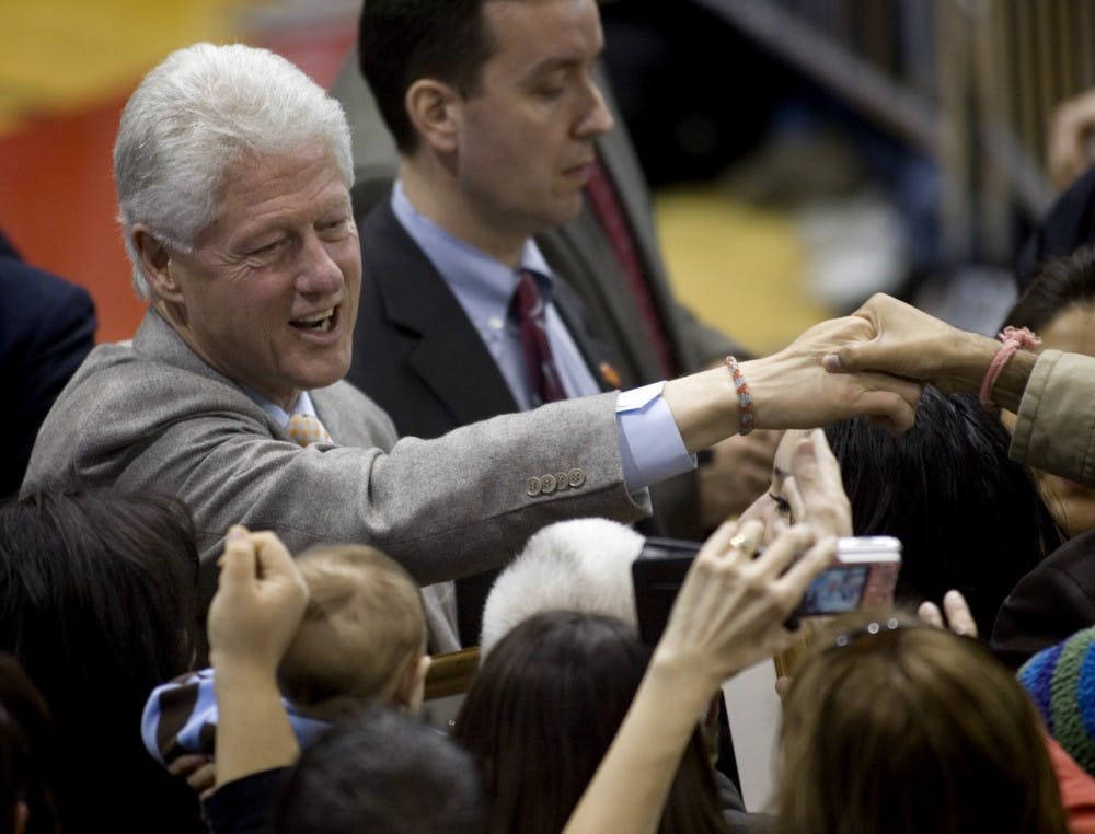 Former President Bill Clinton shakes hands Thursday after speaking in Johnson Center. Clinton was campaigning for his wife, Sen. Hillary Clinton of New York.