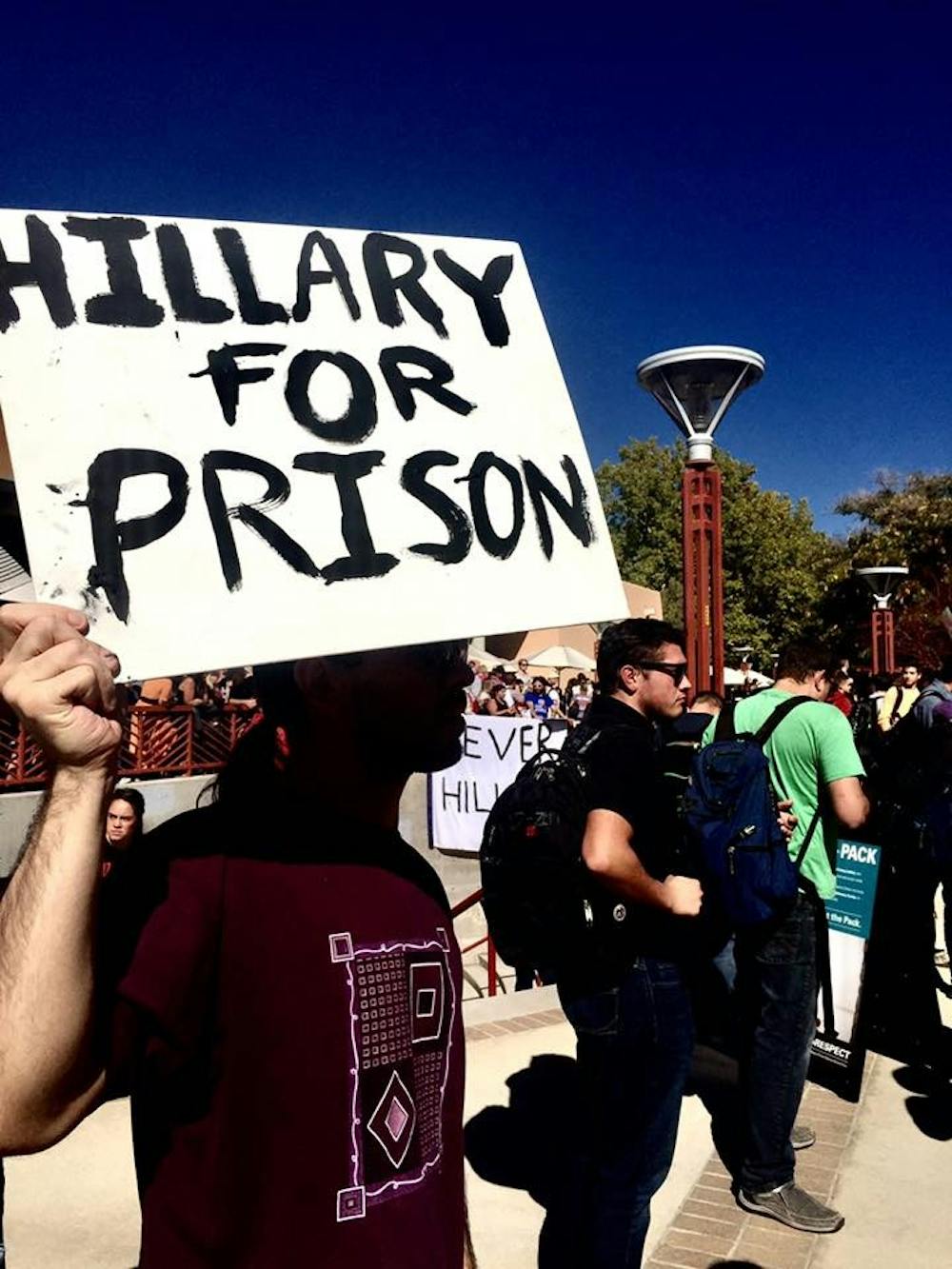 A rally attendee waves an anti-Hillary Clinton sign at the rally in which Bernie Sanders campaigned for the Democratic presidential nominee at UNM on Tuesday, Oct. 18, 2016. Other anti-Clinton proponents and third-party supporters watched and made outspoken comments of their own outside the SUB.&nbsp;