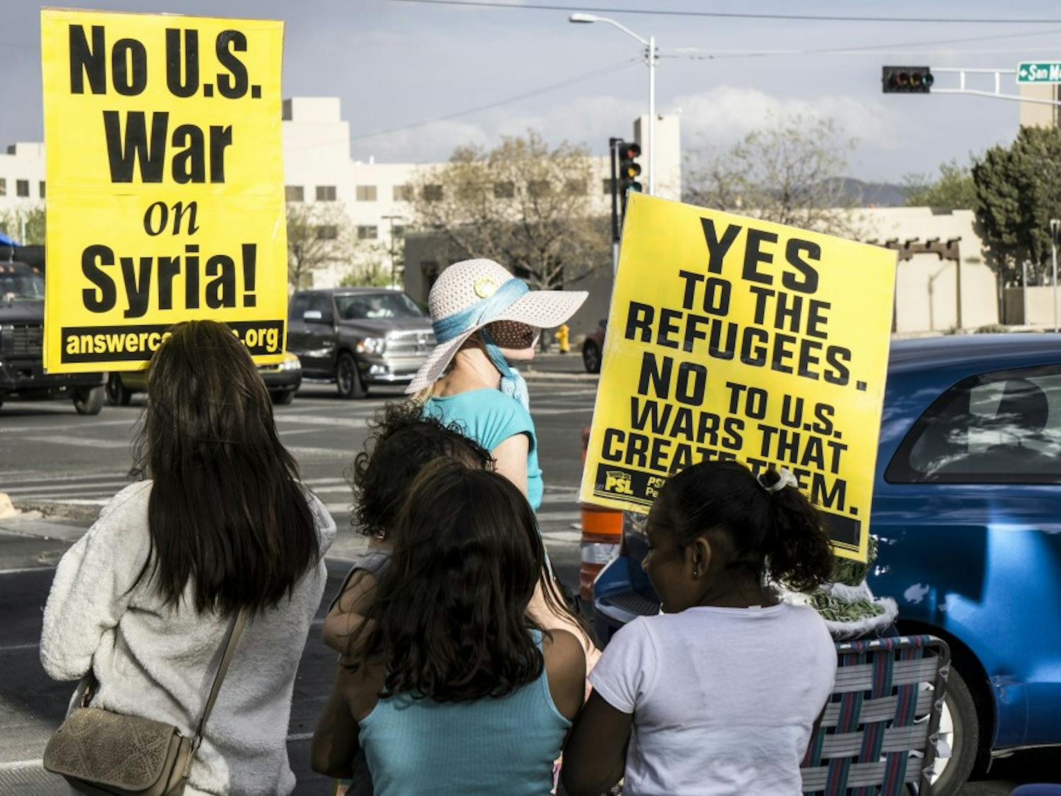 Albuquerque protesters gather on April 12, 2018 at the corner of Girard and San Mateo to protest in response to a tweet by President Donald Trump concerning a possible airstrike on Syria.