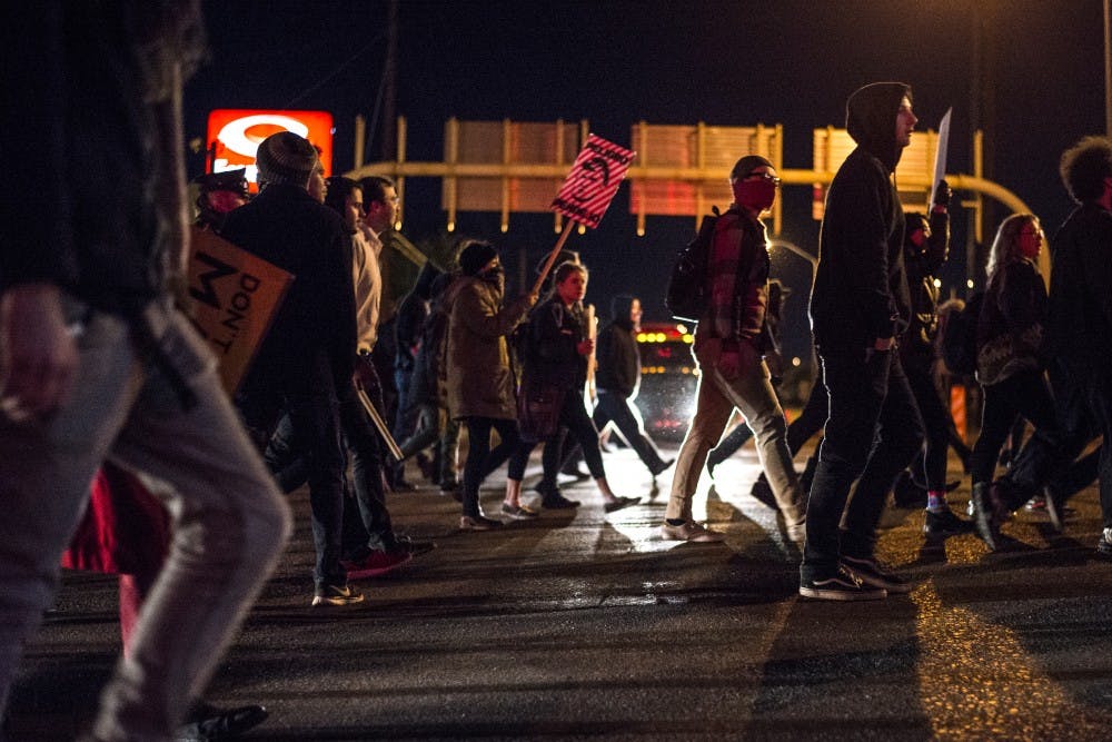 Demonstrators march east on Central Avenue towards UNM during a ant Donald Trump protest Wednesday, Nov. 9, 2016.&nbsp;