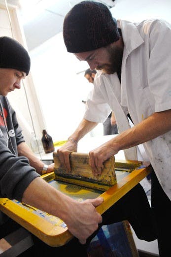 Pat Bannan, left, and James Black of PaperChasePress make a T-shirt at Trillion Space on Monday. They will make and sell T-shirts during Wednesday's presidential debate, which will be viewedEE in the SUB.  