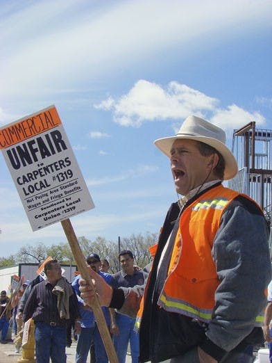 Protester Jerry Vlach yells during a demonstration on North Campus on Wednesday. The event was organized by the Southwest Regional Council of Carpenters, which represents workers in five states. The group is involved in a labor dispute against Commercial 