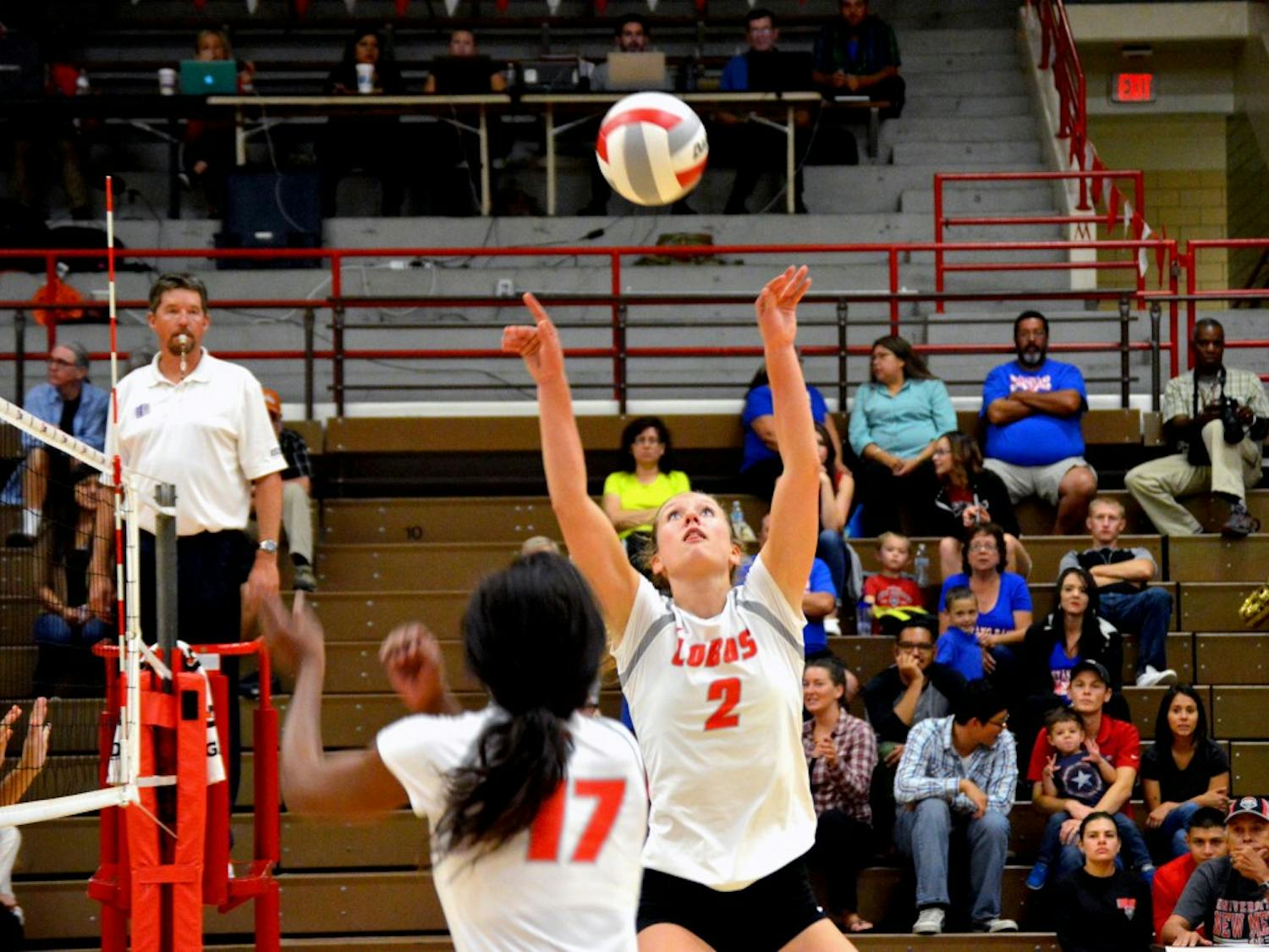 Lobo's setter Hannah Johnson sets the ball for Skye Gullatt during their game against San Diego State Thursday night. The Lobos started the Mountain West opener with a 3-0 loss against the Aztecs. 