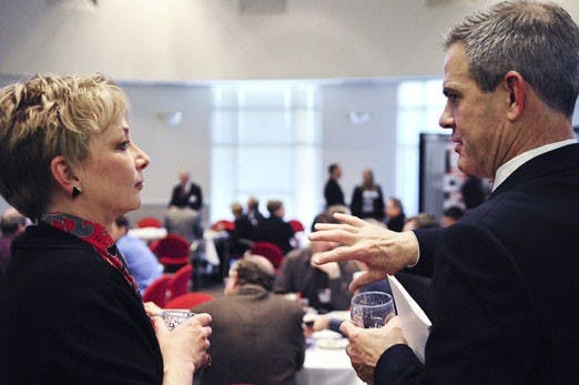 Mary Schmidt, left, and Bill Hartman converse during a reception at the Science & Technology Park Rotunda on Monday. STC.UNM hosted the event to honor 34 researchers whose work earned 22 patents and copyrights this year.