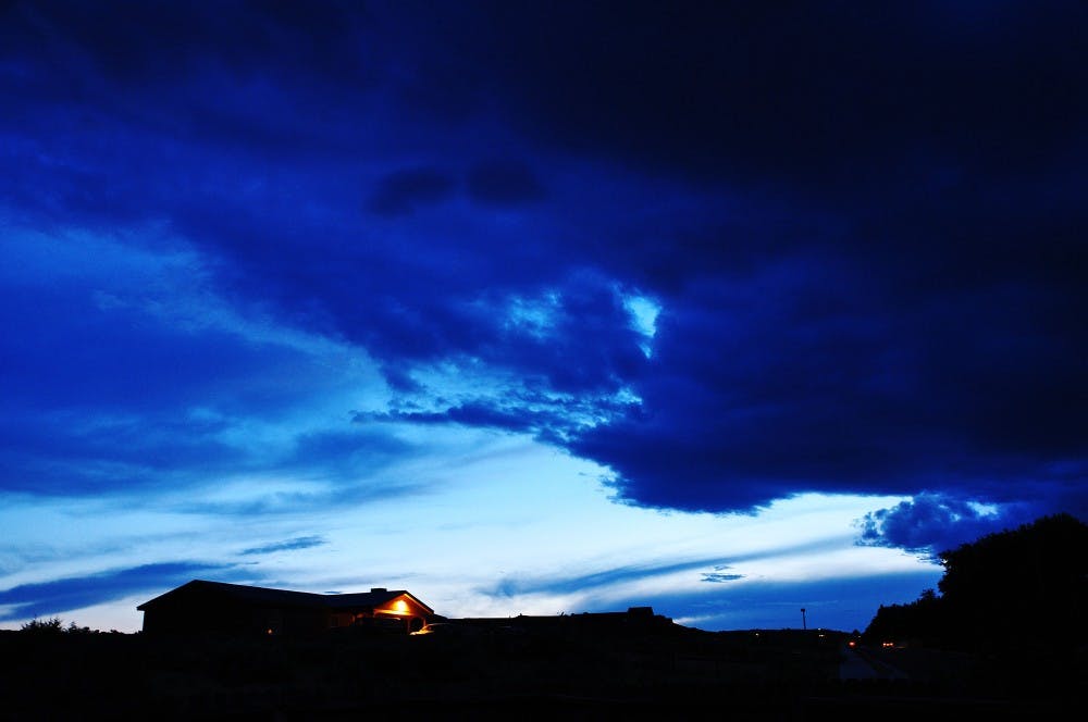 	Abigail Ramirez 
Colliding with the Night 
Colors from a sunset and thunderstorm mix over the Rio Rancho sky, turning the clouds shades of blue and black. The cold breeze made it a nice night to stay indoors by the fire reading a novel. 