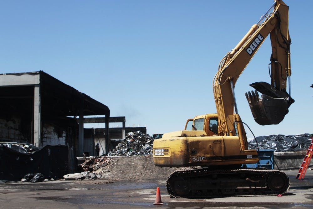 	Construction workers began cleaning the remnants of the charred warehouse once home to UNM Hospital’s medical records. The structure suffered devastating damage from a fire this summer.