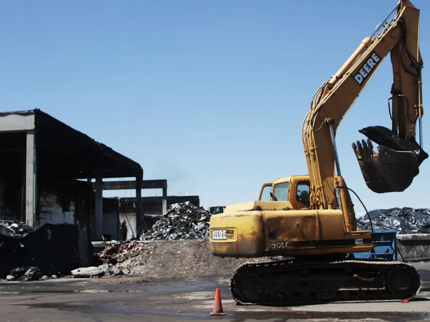 Construction workers began cleaning the remnants of the charred warehouse once home to UNM Hospital’s medical records. The structure suffered devastating damage from a fire this summer.