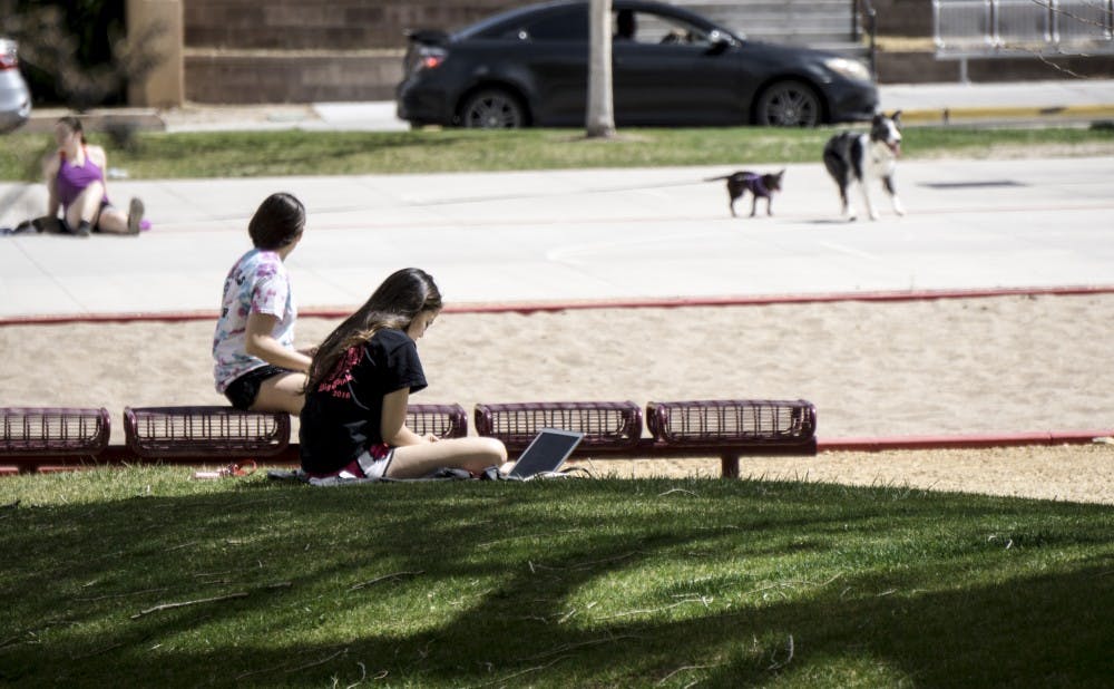 UNM students spend time outside the dorms on March 25, 2018.
