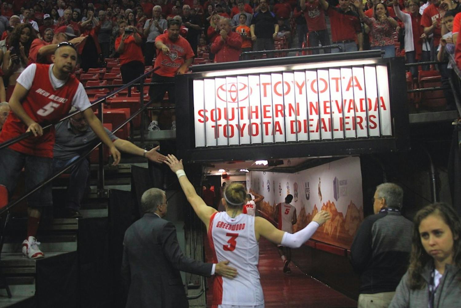 New Mexico senior guard Hugh Greenwood high-fives fans as he walks off the Thomas &amp; Mack Center floor Wednesday afternoon, moments after the Lobos lost to Air Force 68-61 in the Mountain West Basketball Championship opening round.