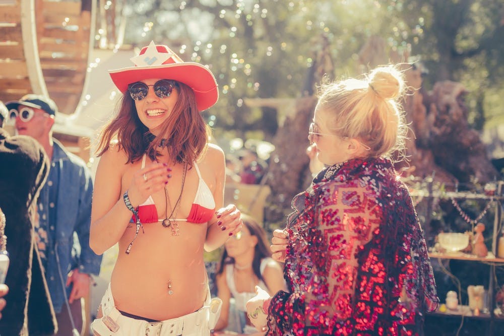 Friends enjoy the sunshine and techno beats at Desert Hearts Music Festival 2017 in Los Cototes Indian Reservation, California.