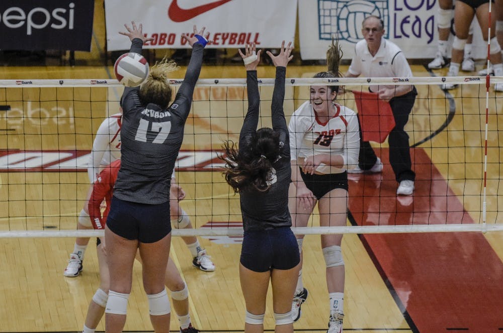 Hailey Rubino spikes the ball past University of Nevada blockers Shayla Hoeft&nbsp; and Dalyn Burns at UNM's Johnson Gym, November 4, 2017. The Lobos were defeated by the Wolf Pack, 3 sets to 1 on Saturday afternoon.&nbsp;