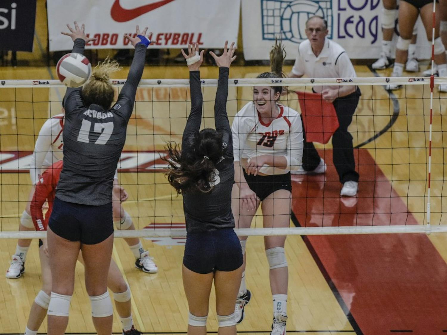 Hailey Rubino spikes the ball past University of Nevada blockers Shayla Hoeft&nbsp; and Dalyn Burns at UNM's Johnson Gym, November 4, 2017. The Lobos were defeated by the Wolf Pack, 3 sets to 1 on Saturday afternoon.&nbsp;