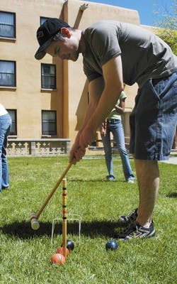 UNM student Aaron Roth plays croquet in the Hokona Hall courtyard Wednesday afternoon. 