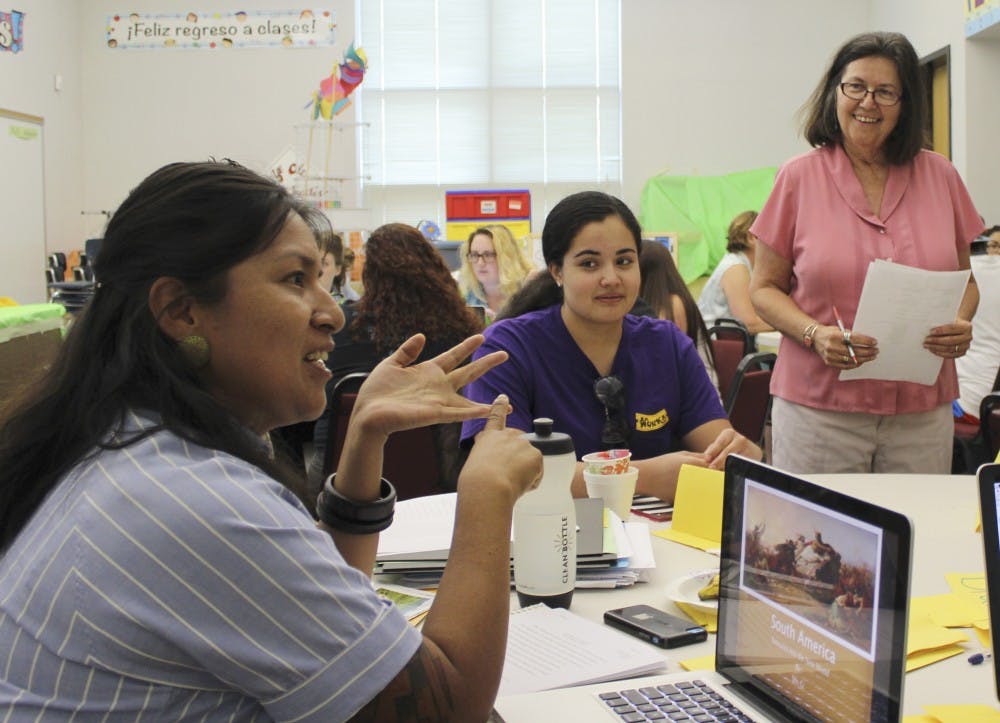 Lizette Gutierrez discusses her teaching projects and language concepts with adjunct faculty staff member Donna Garcia and Gutierrezs fellow classmates during the ESL summer program on Thursday morning. The ESL summer program, held at La Mesa Elementary School, aims at helping families and individuals reach a high proficiency of English language education. 