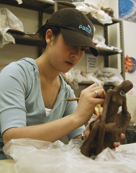 Student Zian Ding works on a clay figure Friday in the ASUNM Crafts Studio in the SUB. 