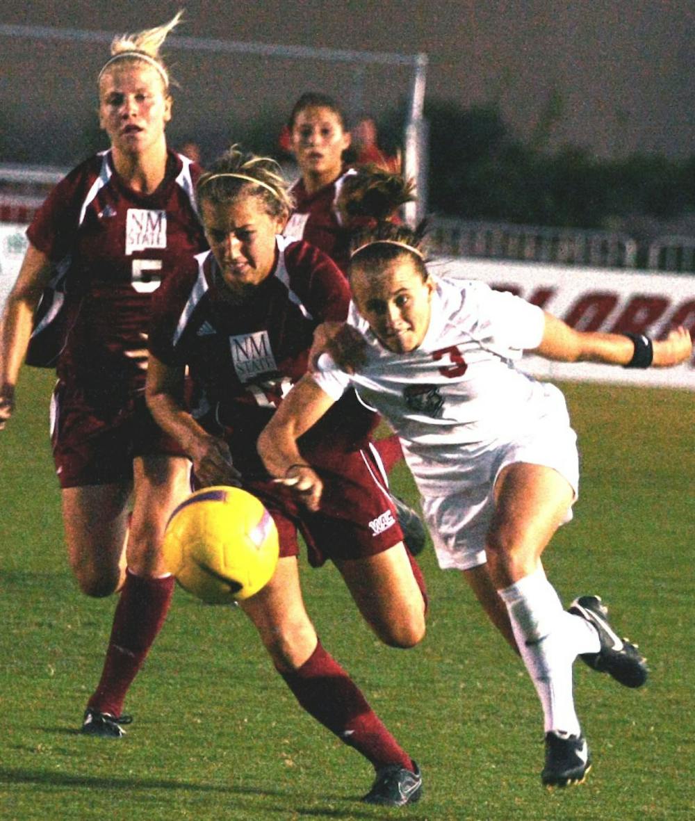 	UNM forward Jennifer Williams tries to maintain control of the ball from NMSU’s defender Elise Nordin. The Lobos pulled out a 1-0 victory over the Aggies on Friday.