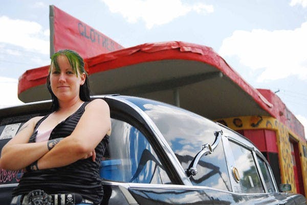 Free Radicals co-owner Nan Morningstar leans on her 1960 Cadillac hearse at her 300 Yale Blvd. S.E. store. The store is celebrating its fifth anniversary with a new location. 