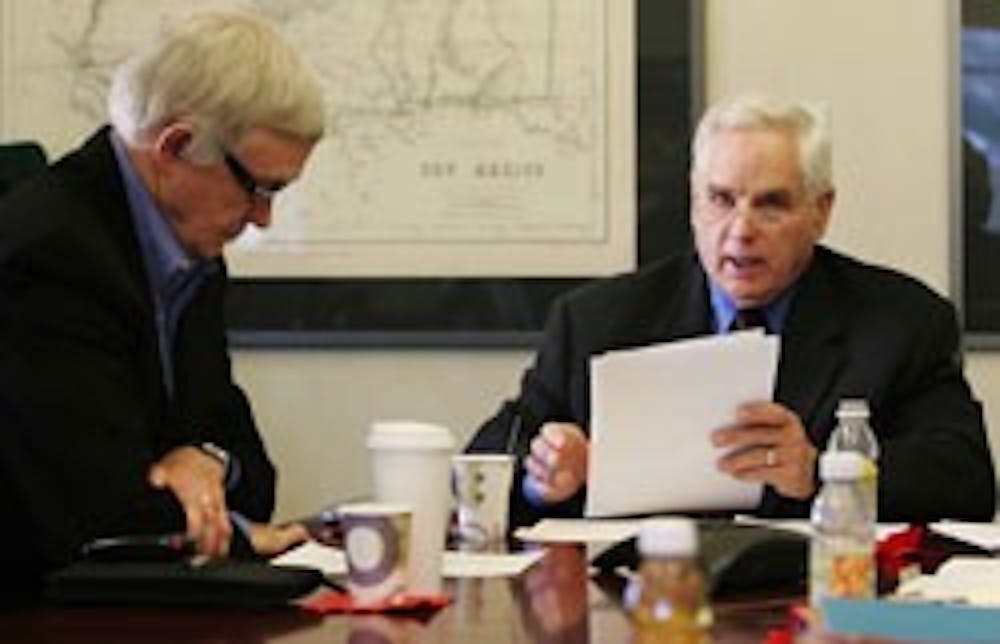 Regents Mel Eaves, left, and Jamie Koch discuss the five finalists for UNM president in a meeting held in Scholes Hall on Wednesday. 