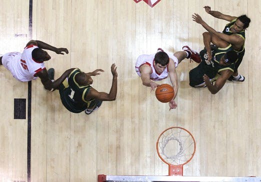 Daniel Faris slashes between three Colorado State defenders on the way to the basket. UNM won 68-50 at The Pit on Wednesday.