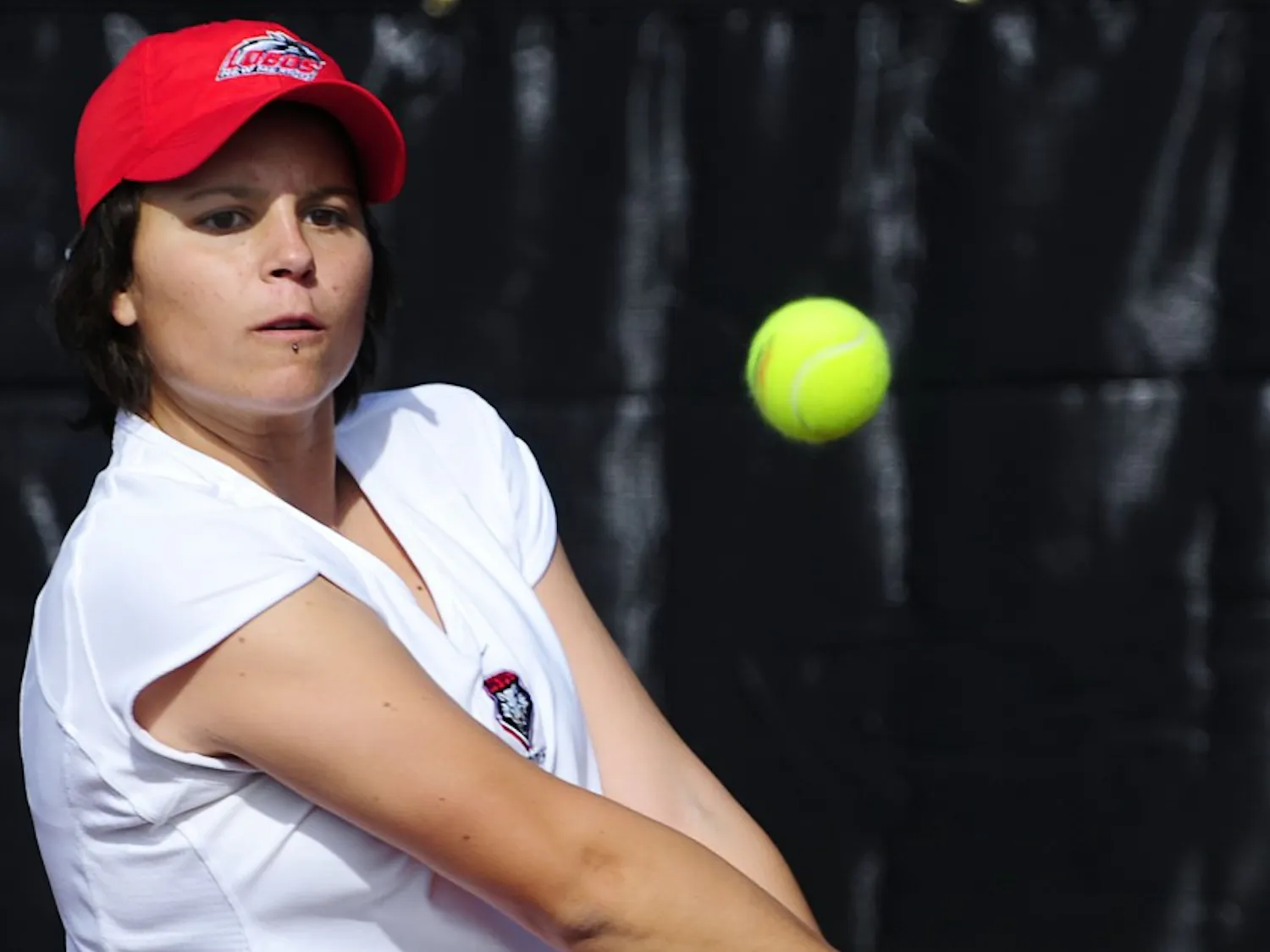 Anya Villanueva, seen here blasting a ball crosscourt, brings two years of college experience to an otherwise young UNM women’s tennis team. The Lobos will look to overcome their youth in the spring season.