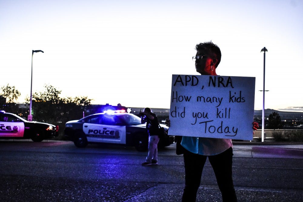 A protestor holds a sign during an anti-NRA protest on Sept. 23, 2018.
