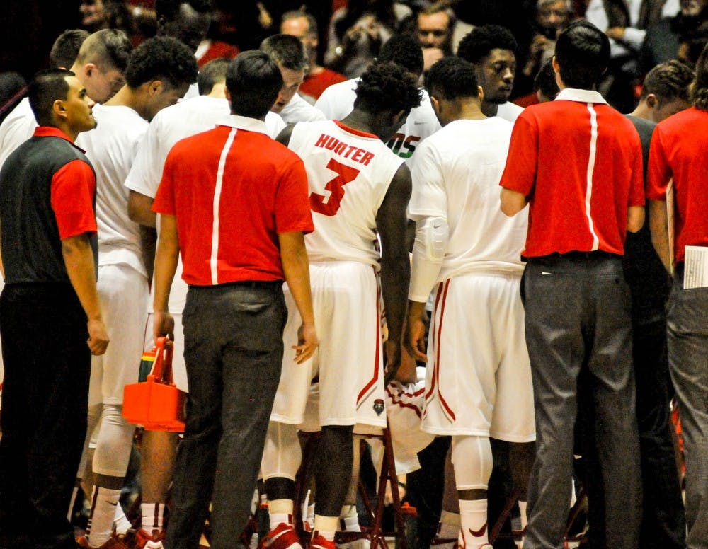 Former Lobo point guard Jordan Hunter joins a group huddle on Feb. 2, 2016 during a game against University of Las Vegas Nevada at the Dreamstyle Arena. Hunter was the last and most recent one of six UNM basketball players to find a new home. 
