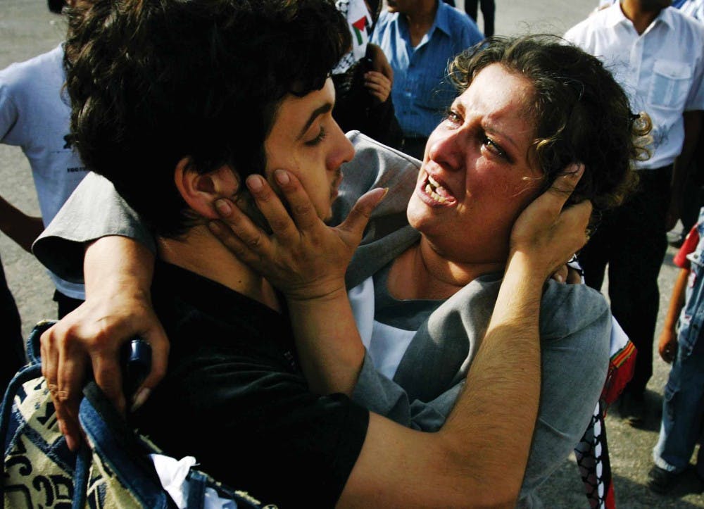 Mohammed Al Banna, 17, greets his mother at the Palestinian side of an Israeli army checkpoint at Beituniya after his release from Israeli jail Monday. 