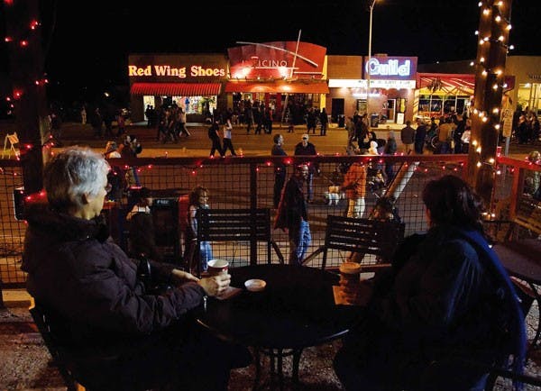 Susan Quintana, left, and Fredine Lauer drink coffee at Starbucks on Central Avenue after shopping during the city-sponsored Shop and Stroll on Thursday in Nob Hill. 