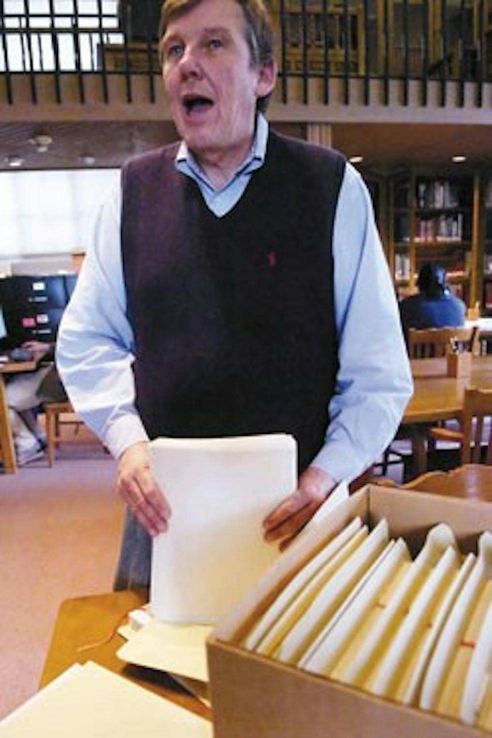 Michael Kelly, director of the Center for Southwest Research, holds Tony Hillerman's drafts in Zimmerman Library on Tuesday. A list of which Hillerman drafts are available at the Center for Southwest Research can be found in the Rocky Mountain Online Arch